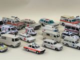 a lot of toy ambulances that are on the table