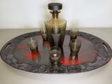 a silver tray with a silver vase and glasses on it