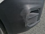a close up of the front bumper of a white truck