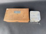 an old wooden box with a metal lid sitting on a table