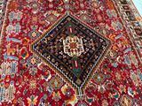 an image of a red rug with a diamond design on it