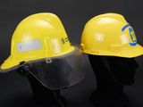 two yellow hard hats with a face shield on top of them