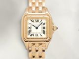 an image of a gold wrist watch with roman numerals on it