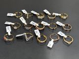 a group of rings with tags on them sitting on top of a table
