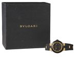 a black and gold watch sitting next to a black box