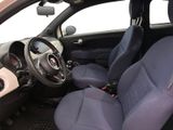 the interior of a small car with blue seats and a steering wheel