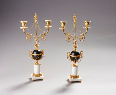pair of gold and white candelabs with black and white vases