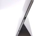 a close up of a laptop on a white surface