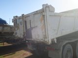 a white dump truck that is parked on the side of the road