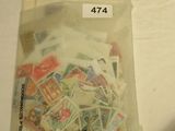 a bag of stamps sitting on a table next to a cell phone