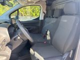 the interior of a small van with a steering wheel and seat covers