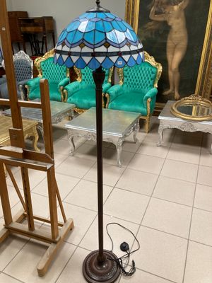 a lamp that is sitting on a stand in a room