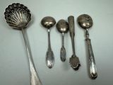 five spoons and two spoon spoons on the table