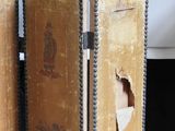 two old books with holes in them sitting on a table