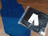 a blue dress and a black shirt on a wooden floor