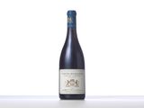a bottle of wine sitting on top of a white table