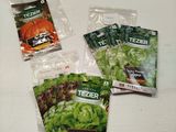 four seed packets of lettuce are sitting on a table