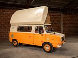 an orange and white van parked in a garage