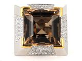 a close up of a ring with a brown stone surrounded by diamonds