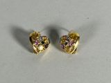 a pair of gold tone earrings with multi colored stones