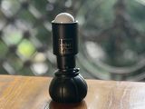 a small black object sitting on a wooden table