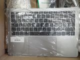 a laptop in a box wrapped in plastic wrap