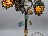 a lamp that has a bunch of grapes on it