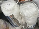 a pile of pillows and a toilet in a room