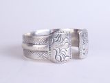 sterling silver ring with engraved design on the sides