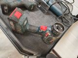 two electric tools that are sitting on a table