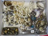 a white box filled with assorted jewelry and accessories