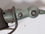 a close up of a metal object on a white surface