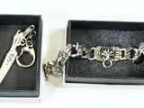pair of scissors in a box with a chain and a keychain