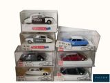 six toy police cars in a display case