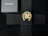 a close up of a cross with a box on a black background
