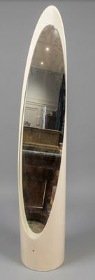 a white oval mirror sitting on a table