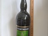 a bottle of liquor sitting on a table next to a ruler
