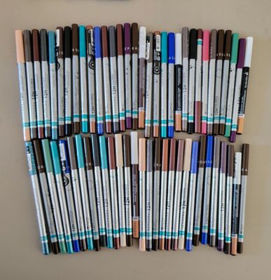 a lot of pens that are lined up on the wall