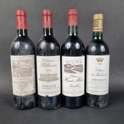three bottles of wine are lined up on a table
