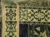 a close up of a piece of cloth with a cat on it