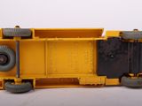a yellow toy truck that is sitting on a white surface