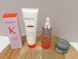 un flacon de Kérastase à côté d'une boîte de produits de soins capillaires