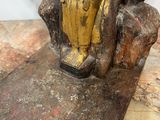 statue of a woman sitting on a rock with a cat on her lap