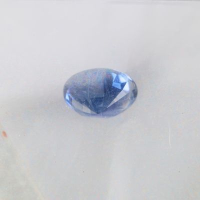 a very large blue stone on a white surface