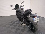 a motorcycle that is parked on a checkered floor