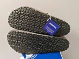 the soles of a pair of shoes are stacked on top of a box