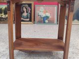 a small wooden table with a shelf on top of it