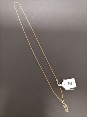 a gold necklace with a tag on it and a chain attached to it