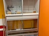 an image of a bird cage in the corner of a room