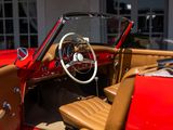 a red car with a leather seat and steering wheel